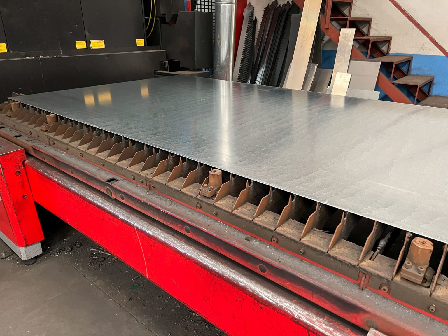 the machine is rolling sheet steel to the next sheet of iron fabricated steel plate